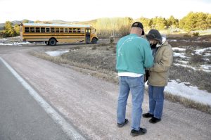 Dave Hoffman and Lynette Perry pray in front of Red Feather Lakes Elementary on Jan. 24, 2013.