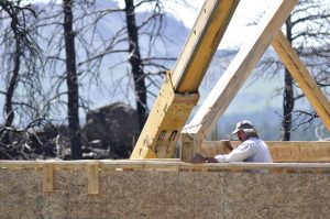 Timber framer Steve Rundquist adjusts a truss on Curt Busby's home off Buckhorn Road.
