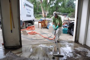John Gavin of Rapid Response cleans mud in the garage of 4124 Green Ridge Drive in LaPorte for homeowner Tom Catlow. There was about 3" of water from the Cache laPoudre, but depths reached about three feet in front of the house. Catlow has flood insurance.