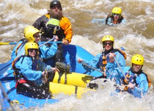 Rafter overboard. This rider to a short ride in the Disneyland drop off on the Poudre River, but was retrieved unhurt.