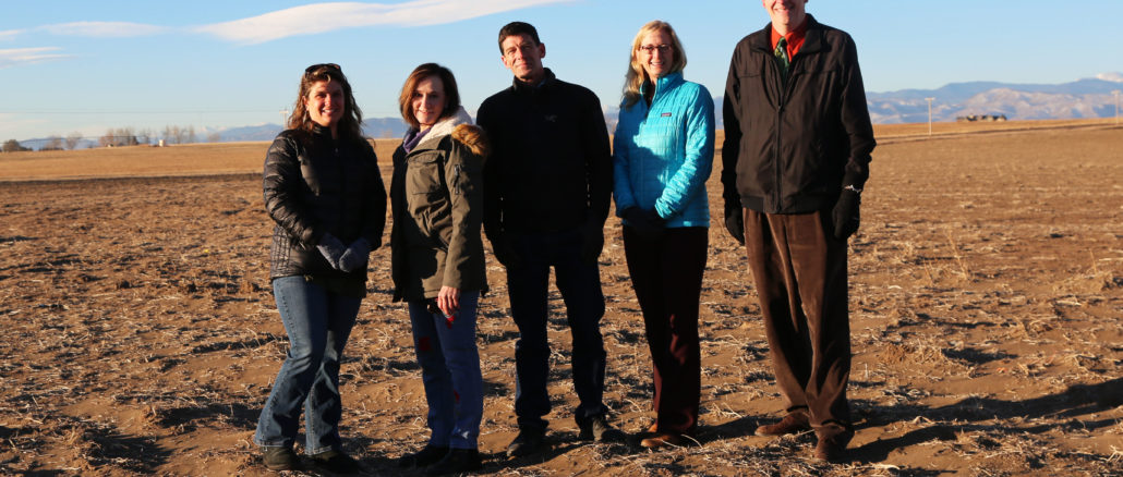 (From left to right) PSD Board of Education Directors Kristen Draper, Carolyn Reed, Christophe Febvre, Superintendent Sandra Smyser and Board Director Rob Petterson pose for a photo on the future site of a new middle/high school in Wellington.