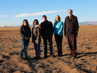 (From left to right) PSD Board of Education Directors Kristen Draper, Carolyn Reed, Christophe Febvre, Superintendent Sandra Smyser and Board Director Rob Petterson pose for a photo on the future site of a new middle/high school in Wellington.