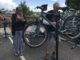 Homeward Alliance mobile bike repair. Bike owner Amy Roth looks on as volunteer Jim Smith adjusts her brakes.
