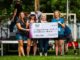 From left: Annie Thomas, Megan Larson, Tara Neckel, and Annie Lindgren, at the Brewfest donation presentation on August 17th at Well-O-Rama Music festival. Not pictured: Mary Gray and Sarah Braun Photo Credit: Brian Graves, GravenImages