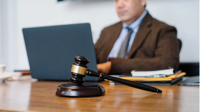 Crop Asian judge working on laptop in office https://www.pexels.com/photo/crop-asian-judge-working-on-laptop-in-office-5668772/